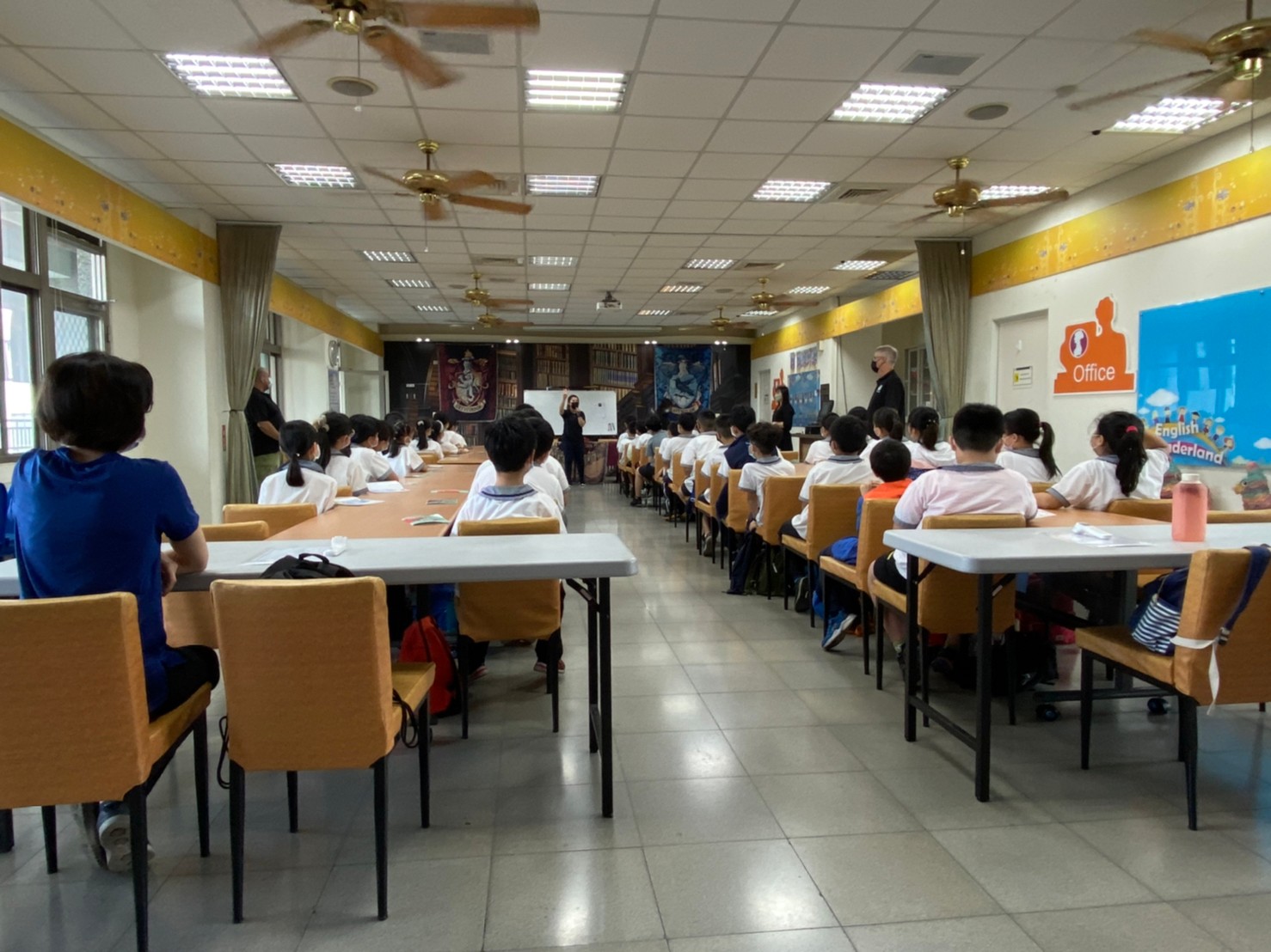 students gather in a big classroom at the end