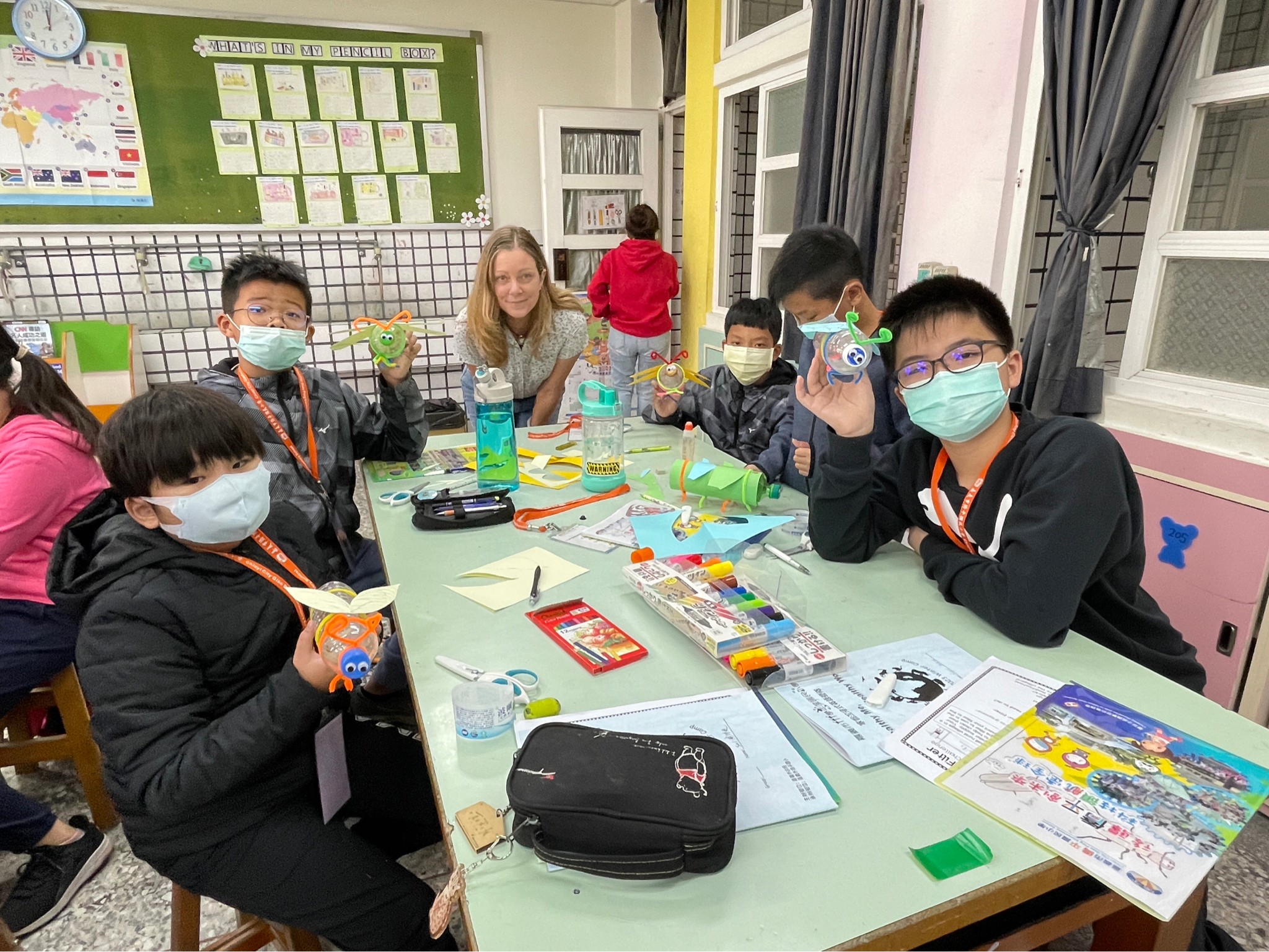 students show their insects