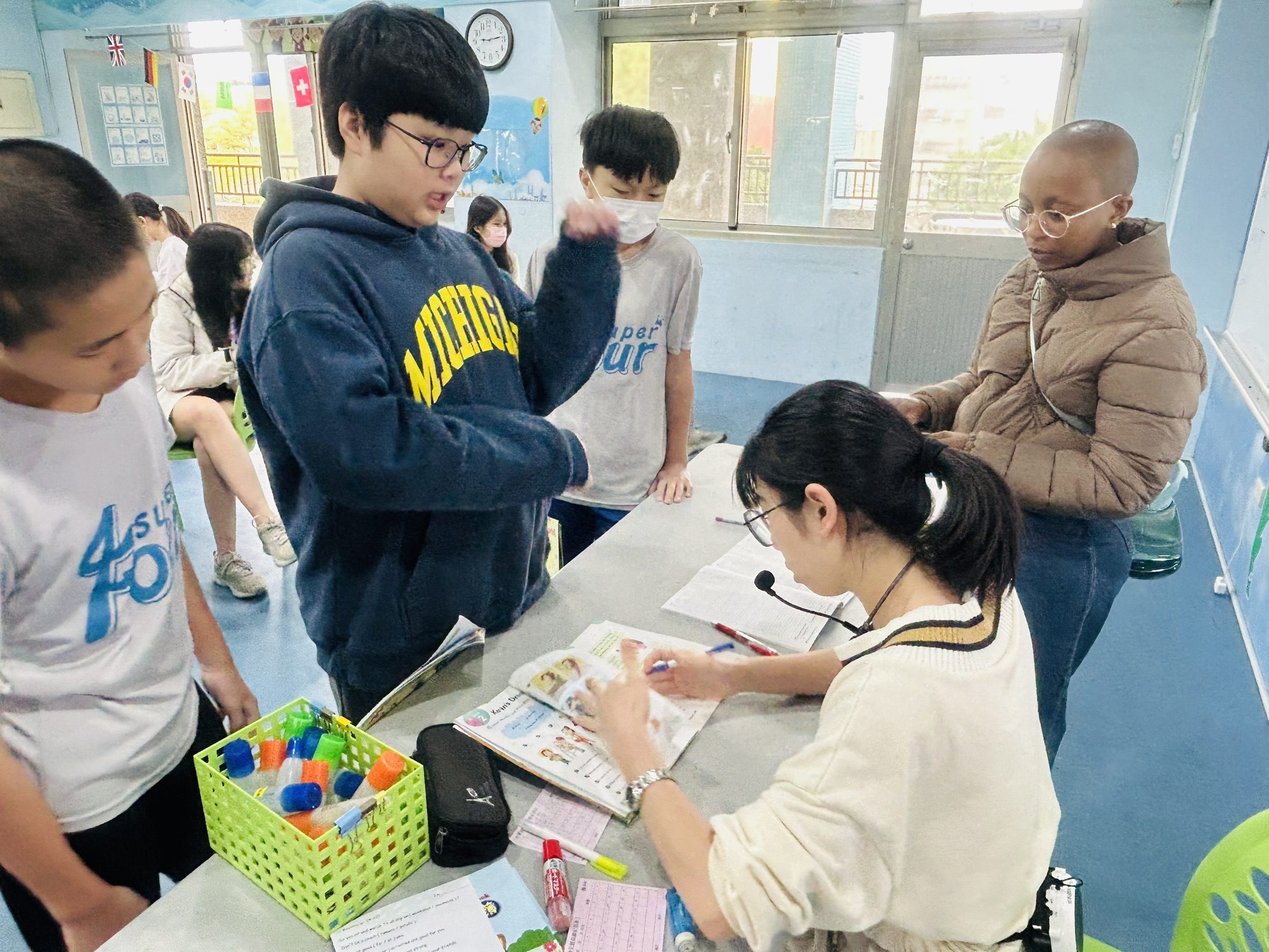 the teacher is checking students homework