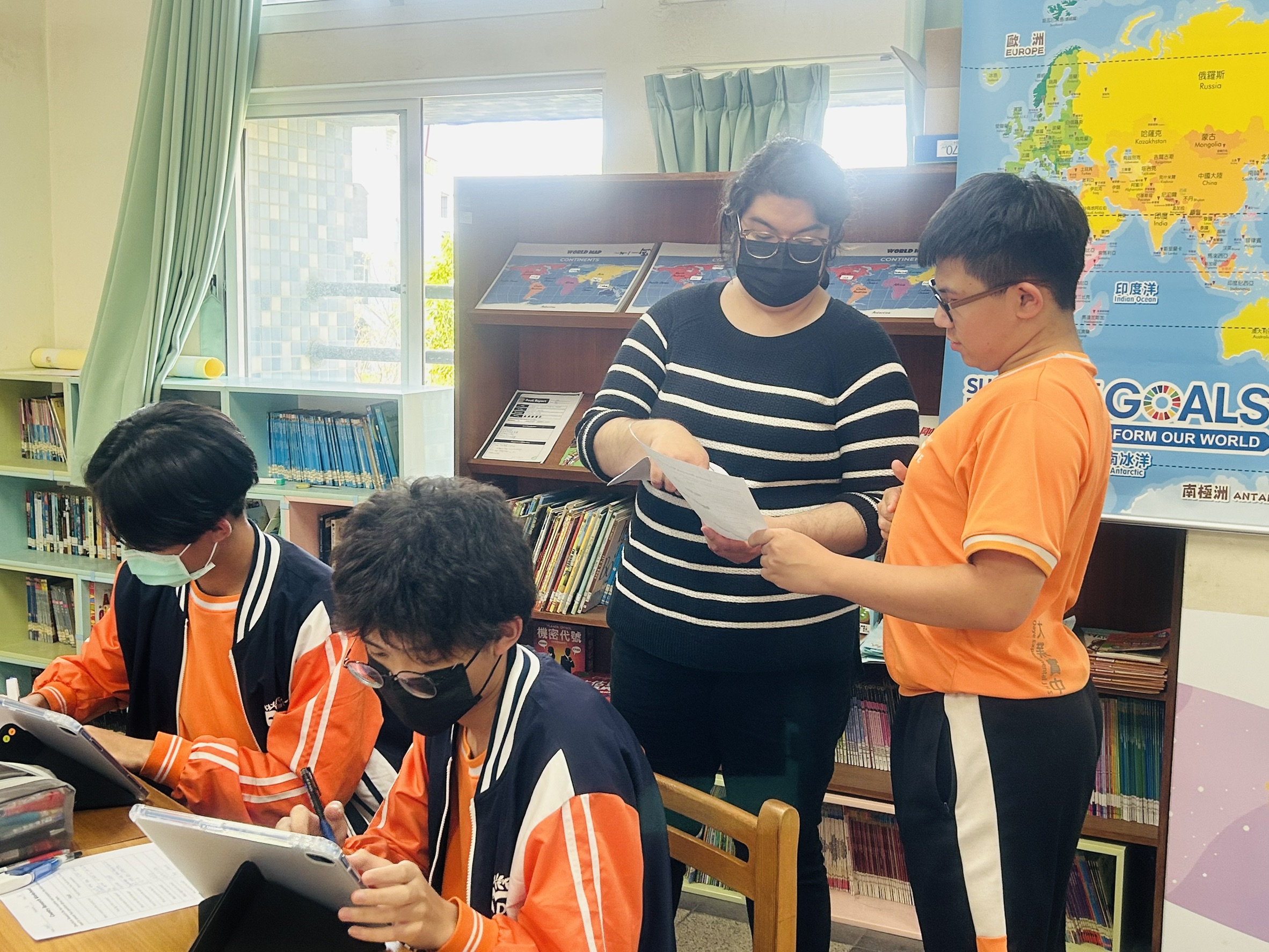 The teacher is checking the student's worksheet